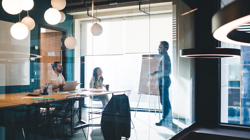 Three business professionals in a SMART goal planning meeting