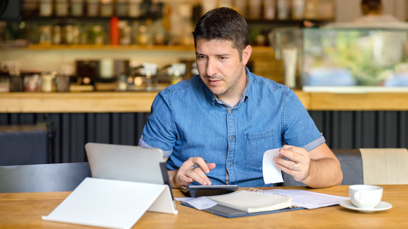 Business owner looking through receipts